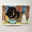 Illustration of a black cartoon cat resting on a log and crying into a small teapot.