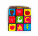 A 3x3 painted cube puzzle on a white background, featuring colorful squares with drawings of a strawberry, tulip, tomato, bow, duck, crescent moon, apple, star, and lightning bolt.
