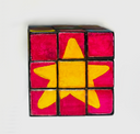 A 3x3 painted cube puzzle featuring a yellow star design on a white background.