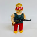 Clay sculpture of a blonde man with spiky short hair and a gun, he wears large red sunglasses, a tank top and red pants. His gun has Japanese kanji written on it.