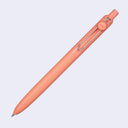 Peach-colored ballpoint pen on a light gray background