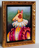 A framed whimsical painting of a dog dressed in a ruffled white collar and a pink, orange, and yellow striped outfit, set in an ornate gold frame against a light gray wall.