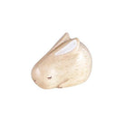 Small wooden rabbit-shaped object on a white background