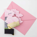 Greeting card with cherry blossom design on a pink envelope