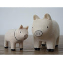 2 small white wooden figurines of pigs - one is larger than the other.