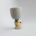 Ceramic gray cup with a brown floppy eared dog as a handle.