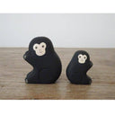 2 small wooden figurines of monkeys - one is larger than the other.