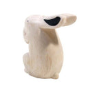 Carved wooden figure of a white rabbit.