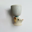 Ceramic gray cup with a brown floppy eared dog as a handle.