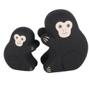2 small wooden figurines of monkeys - one is larger than the other.
