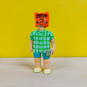 Clay sculpture of a man in blue shorts, a blue and green plaid shirt and yellow shoes. He holds a stack of money and has a bag over his head that reads "bully me for $100"