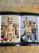 Two monster figures in a cityscape setting on a textured surface.