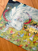 Colorful illustration on a neoprene desk mat of a dragon and fairies in a fantasy landscape with stars and flowers.