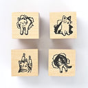 Four wooden stamps with black ink impressions of cats on a white background