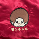Embroidered cartoon character on red fabric with Japanese text