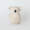 White wooden figurine of a koala, smiling with a cute cartoon facial expression.