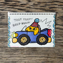 Illustration of a cartoon yellow star, driving a car.