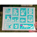 Teal blue ink illustration of many stamps, with various cat and spooky themed drawings.