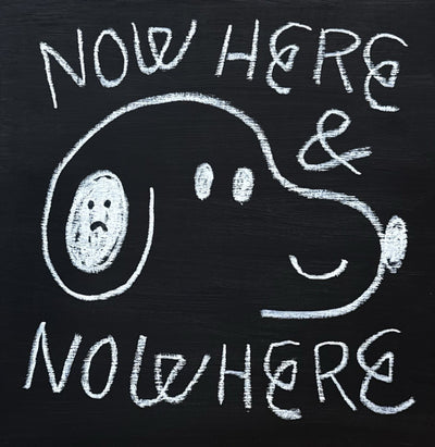 White chalk-like line art on a black wood panel of a cartoon, simplified Snoopy with text that reads "Now Here & Nowhere"