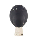 Black and white bird figurine on a white background
