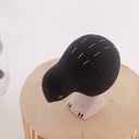 Black and white bird figurine on a white background