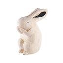 Carved wooden figure of a white rabbit.