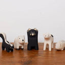 Set of small animal figurines on a wooden surface with a white background