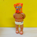 Clay sculpture of a man naked aside from white underwear, standing with his arms behind his back and a chip back over his head that reads "I am president"