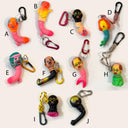 Colorful keychains with unique designs on a white background