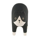 Wooden figurine of a black and natural wood color cat with an arched back.