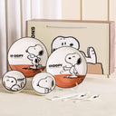 Set of bowls and plates with Snoopy graphics on it.
