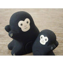2 small wooden figurines of monkeys - one is larger than the other.