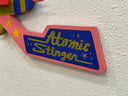 Toy with 'Atomic Stinger' label on a textured white background