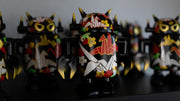 Black spray painted Big Boss Robot figures, with gold, white, red and green color accents. Their robot body features designs of paper cranes, as well as small leaf and flower iconography.