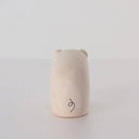 White wood figurine of a pig with a cute smile.