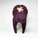 A handmade felted wool animal figure in deep purple with cream-colored shamrock and dot patterns, standing against a plain white background.