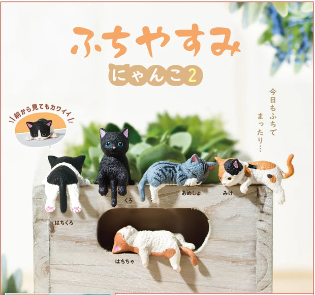 5 small cat figurines, laying or sitting in different positions to indicate they are resting. Colorways vary: tuxedo cat, black cat, gray cat, calico cat and orange and white cat.