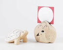 Two wooden animal toys, a turtle and a bird, on a white background.