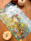 Colorful illustration on a neoprene desk mat of a dragon and fairies in a fantasy landscape with stars and flowers.
