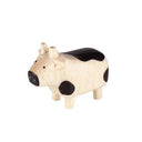 Small figurine of a cow with black spots on a white background
