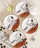 Set of bowls and plates with Snoopy graphics on it.