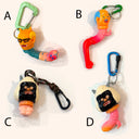 Four colorful keychains with unique designs on a white background