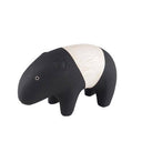 Small wooden figurine of a tapir, black and cream colored .