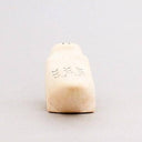 Wooden figurine of a crocodile with a cute, smiling face.