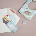 Paper mobile of tea themed illustrations, put into a paper envelope.
