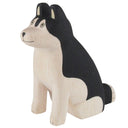 Wooden dog figurine with black and white color pattern on a white background