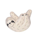 Wooden figurine of a sloth, hanging upside down.