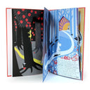 An open illustrated book with multiple illustrated pages spread open, showing a whimsical forest scene with red apples, blue trees, Moomin, and printed text on the lower right page.