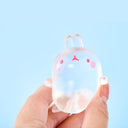 Transparent squishy of a chubby bunny, being held in someone's hand on a light blue background
