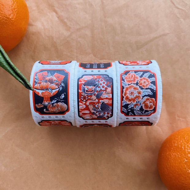 3 rolls of washi tape with Asian inspired illustrations in orange, black and white.